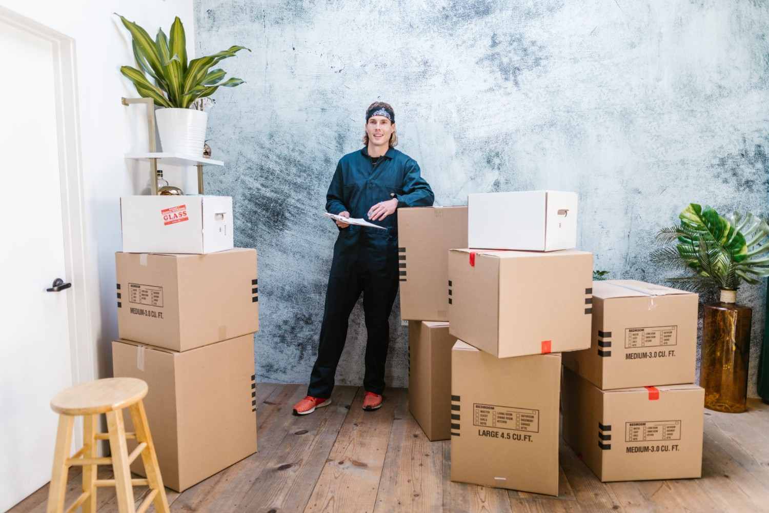 Person standing by stacked boxes